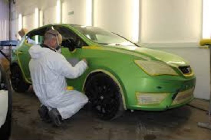 Two men moving boxes through an office hallway, facilitating a Car Body Repairs in Wooburn Green